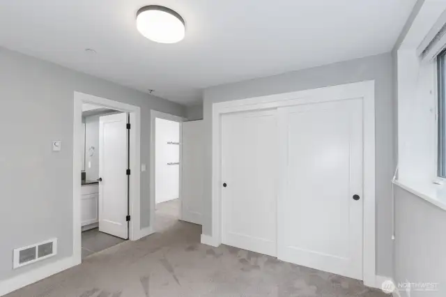 Looking the other direction in the guest bedroom with the door to the bathroom on the left.