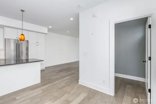 Looking from the top of the stairway on the main level with the powder room to the right and the kitchen to the left.