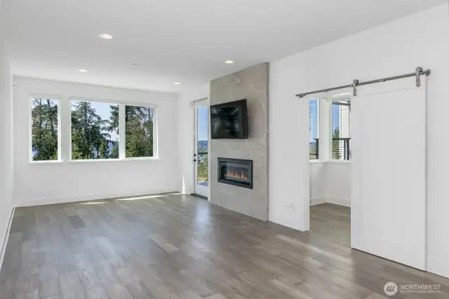 The barn door is to the office. Note the cozy gas fireplace. The glass door is to the view deck.