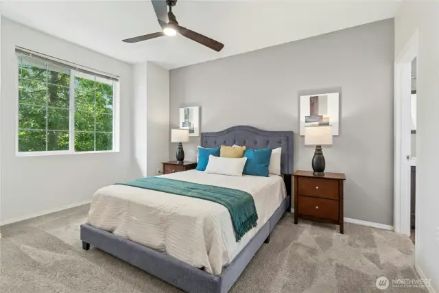 Large primary bedroom with celing fan.