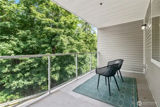 Large covered deck overlooking green belt.