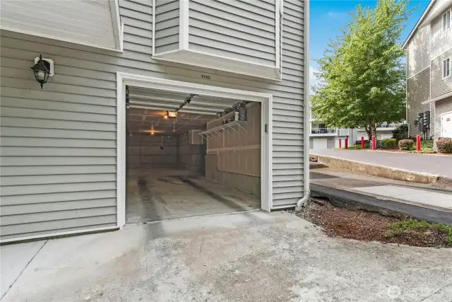 Deep tandem car garage with extra space outside of it.