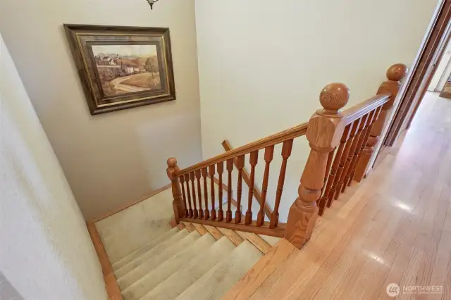 staircase from upper level to lower level- original hardwood floors on upper level