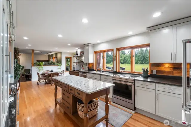 Kitchen island adds extra counter space and storage. Don't miss the granite countertops and rustic barnwood backsplash!