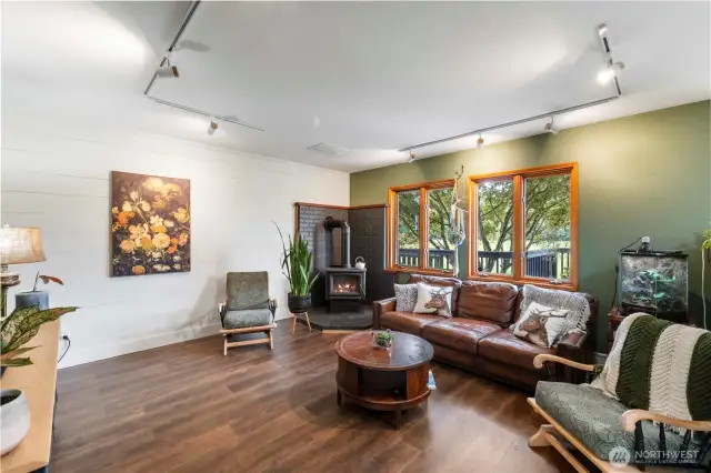 Living room features a freestanding wood fireplace for ambiance and those chilly winter nights.