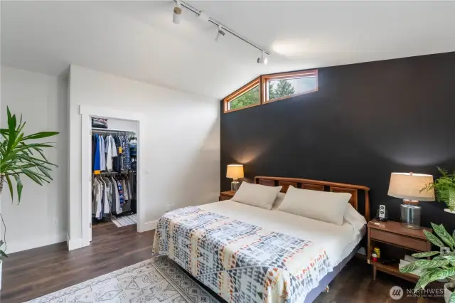 Another view of the primary bedroom showing the walk-in closet.