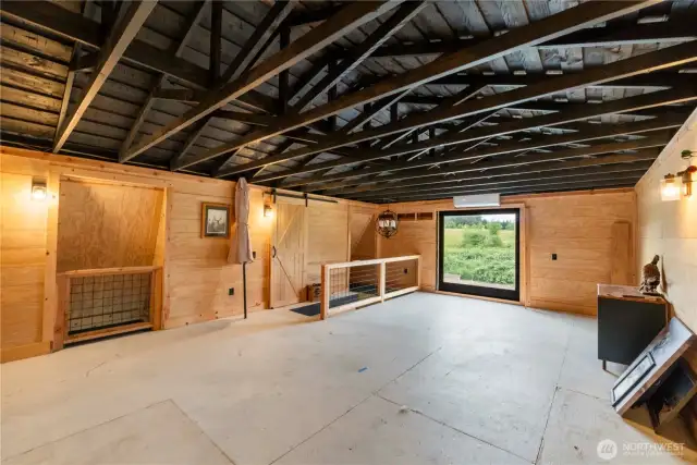 The upstairs loft features a chandelier, ductless HVAC, and a large window overlooking the property.
