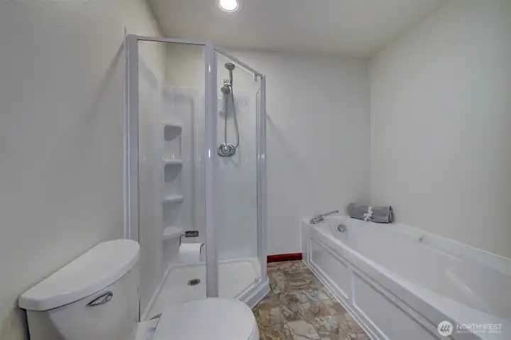Primary attached full bath with soaking tub.