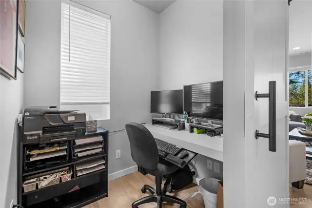 Office space with sliding door off hallway
