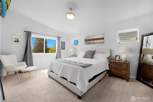 Primary bedroom with vaulted ceilings, tons of light and backs to orchard greenery