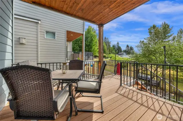 Back deck dining that is accesses through slider from interior dining room.  Backs to orchard greenery