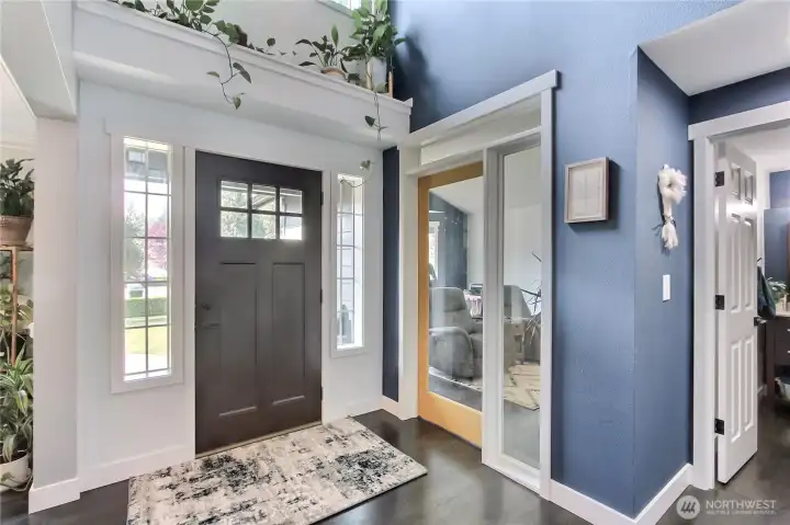 This photo showcases a welcoming and expansive entryway, flooded with abundant natural light that creates a bright and inviting atmosphere for all who enter.