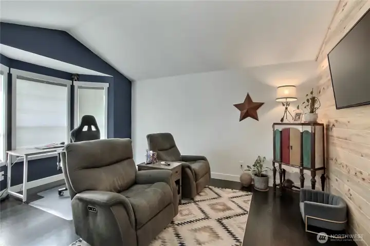 Cozy media room for entertainment. This space is designed for relaxation and shared viewing experiences, perfect for movie nights, game days, or simply unwinding after a long day.