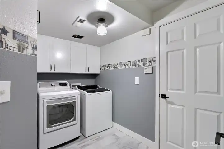 This property boasts a generously sized laundry room, complete with built-in storage cabinets, providing excellent organization and functionality for all your household needs.