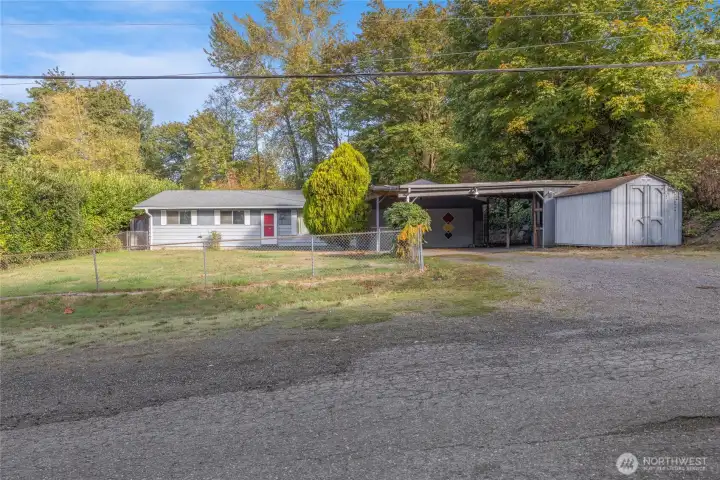 Home view with carport and shed