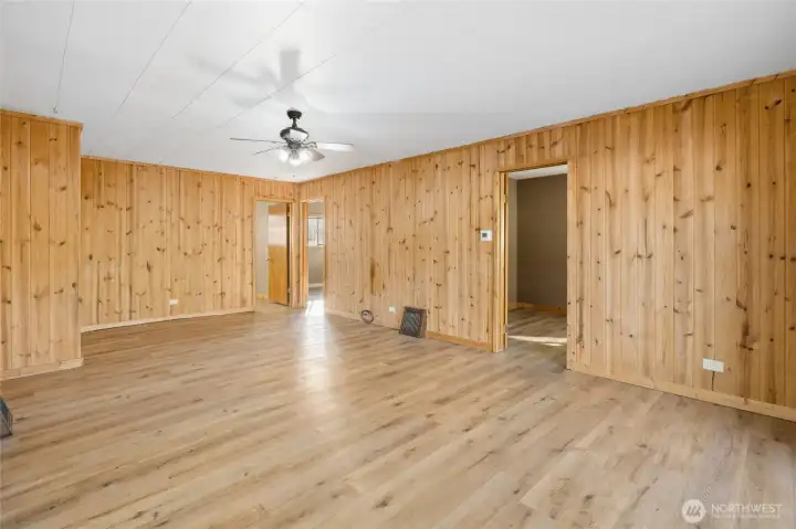 Living space with access into two bedrooms and office.