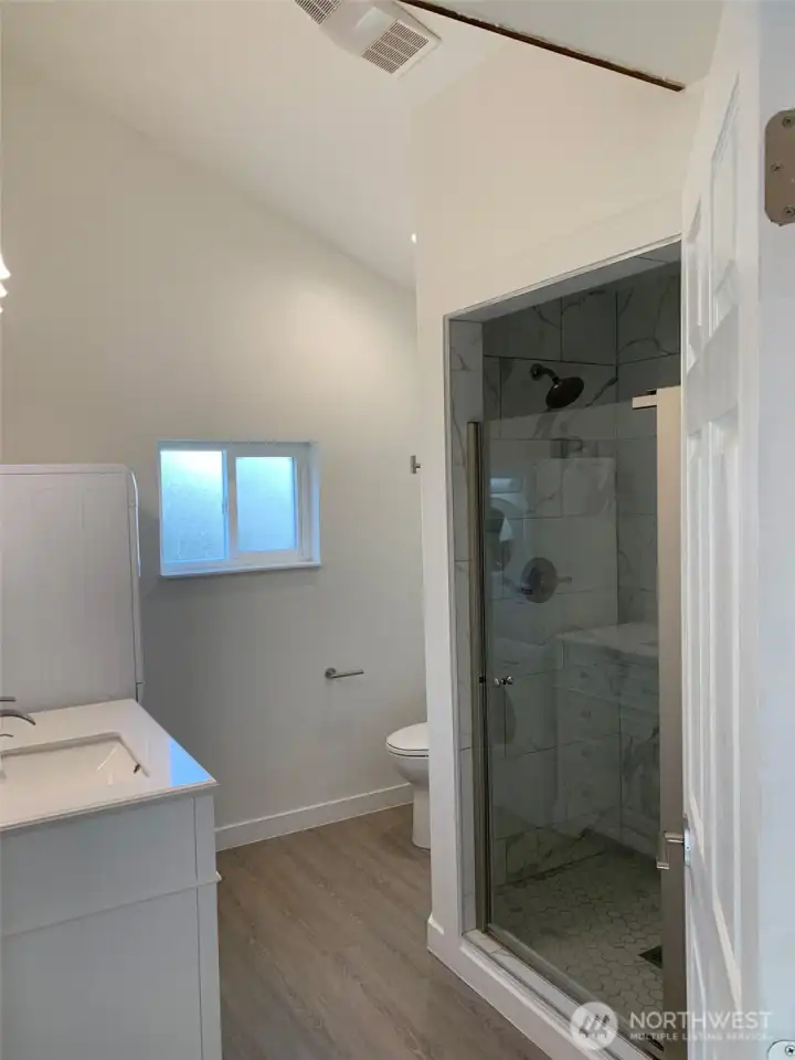 Full bathroom with washer and dryer in the ADU