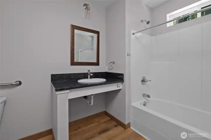 Guest bathroom, spacious with granite countertop.