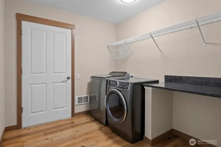 Large laundry room with access to the garage. Granite countertop and plenty of storage.