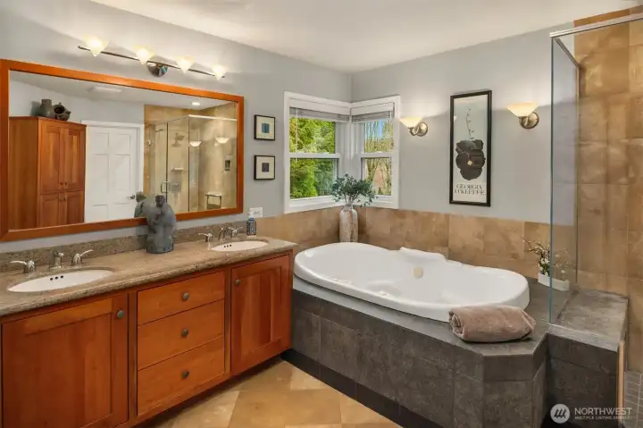 Primary 5 pc ensuite with limestone floors and shower, cherry cabinetry and lg soaking tub