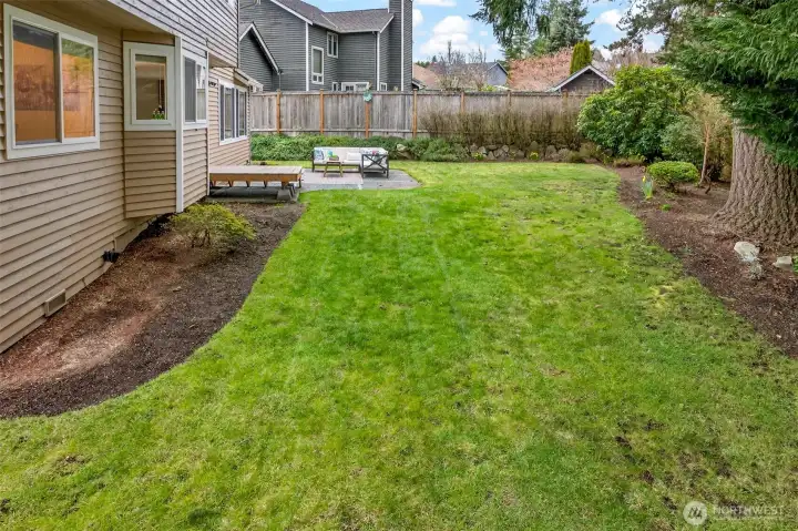 The generous lawn offers flexibility for recreation, gardening, pets, or simply enjoying more outdoor space at home. Buyers looking for a yard that is both usable and private will find real value here.