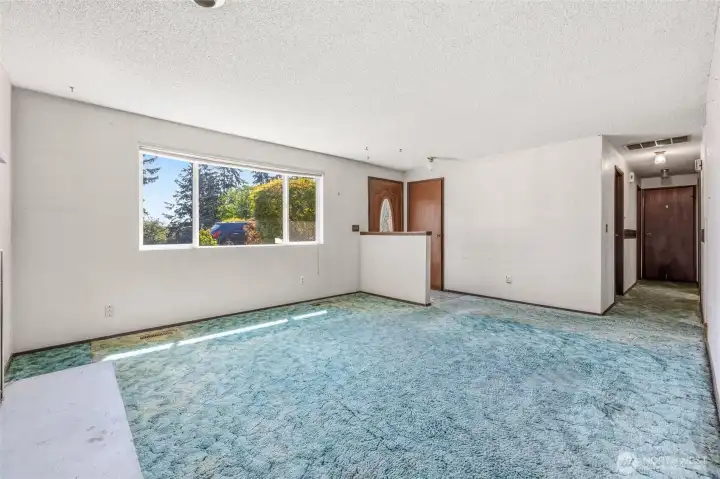 Home enters into living room which is open to dining space.  Hall leads to beds and baths. It is light and bright and ready for you to make it your own.