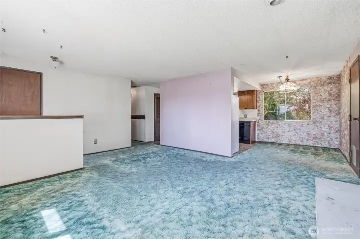 View to dining area. Door on right leads to two car garage. Door way in center leads to laundry area and door to back yard.