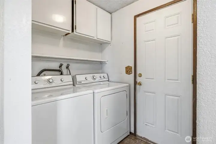 Great laundry space off kitchen with extra storage.  Door to back yard.