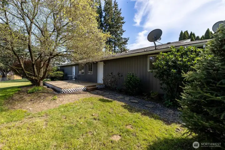 Large back yard with deck off kitchen/laundry area.