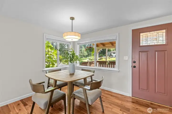 Dining area with updated fixtures and the coziest nook with windows over the pasture and front porch.