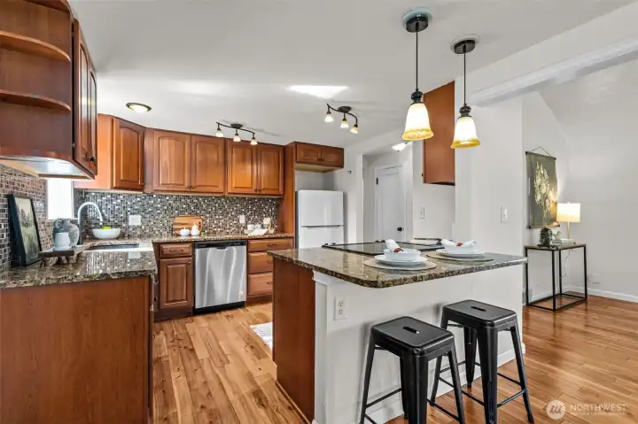 Updated kitchen with plenty of storage and an eat in bar/island.