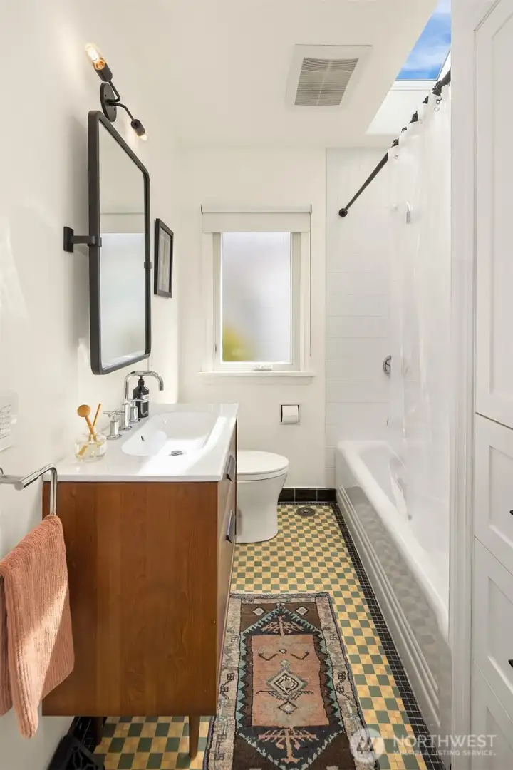 updated main level bathroom with skylight and heated floors.