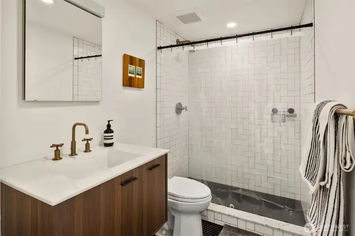Stylishly remodeled lower level bathroom with large shower and heated floors.