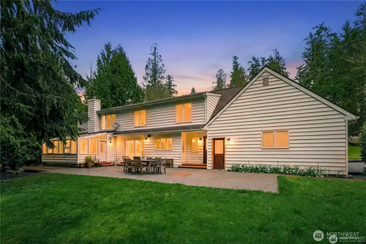 Backside of home shows off the large patio and sunroom