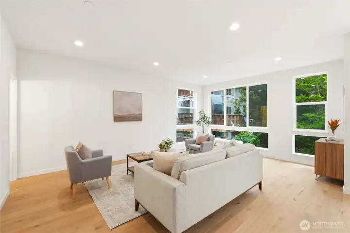 generous living room with nearly floor to ceiling windows