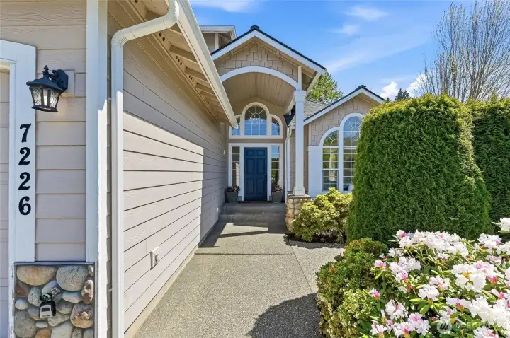 A stunning walkway creates a warm and welcoming approach to the front door
