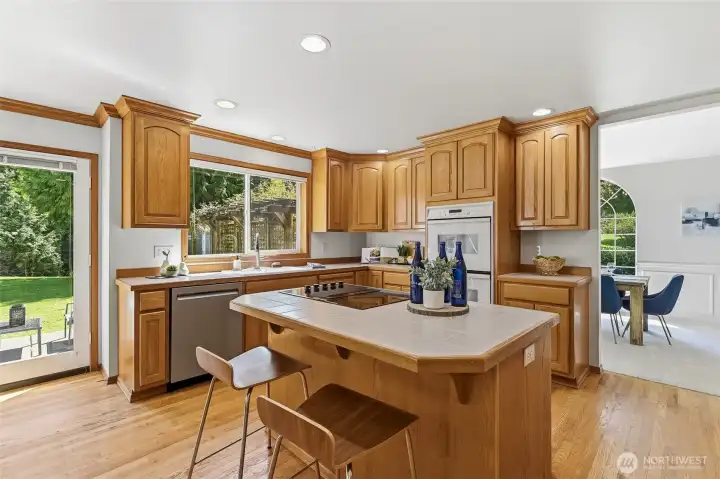 Central island cooktop combines functional prep space with seating - ideal for cooking and entertaining.