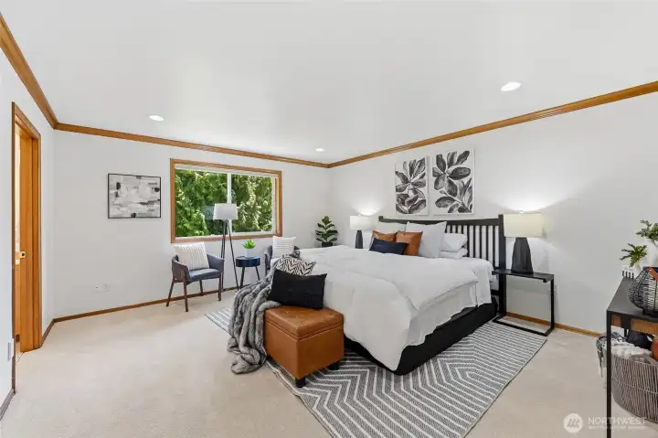 Expansive primary suite offers serene views overlooking the private backyard