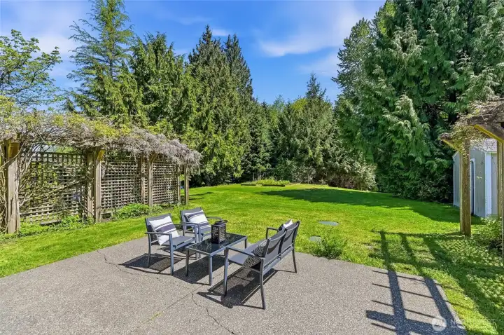 Beautifully private back patio offers an ideal space for relaxing afternoons and guest entertaining. Storage shed for landscaping materials will convey to Buyer