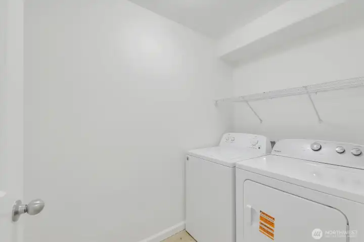 Separate laundry room with room for storage.