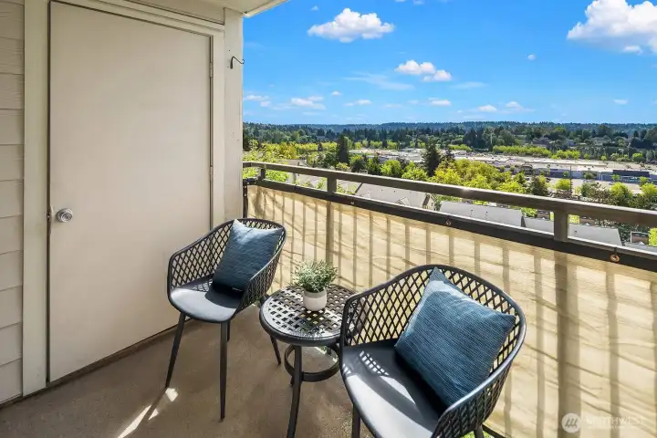 Another angle of the private balcony highlighting the expansive views and comfortable outdoor seating, ideal for morning coffee or evening sunsets. Another angle of the private balcony highlighting the expansive views and comfortable outdoor seating, ideal for morning coffee or evening sunsets.