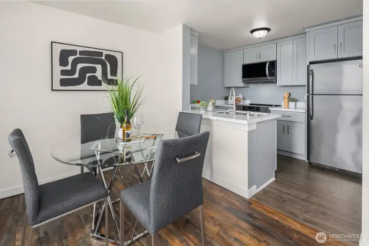 Well-appointed kitchen and dining area featuring quartz countertops, ample storage, and rich hardwood floors flowing seamlessly throughout the space. Well-appointed kitchen and dining area featuring quartz countertops, ample storage, and rich hardwood floors flowing seamlessly throughout the space.