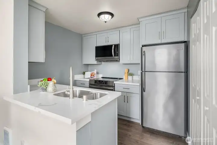 Functional and stylish kitchen featuring quartz countertops, updated stainless steel appliances, and plenty of cabinet storage to meet all your culinary needs. Functional and stylish kitchen featuring quartz countertops, updated stainless steel appliances, and plenty of cabinet storage to meet all your culinary needs.