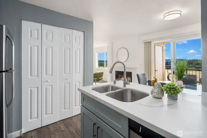 Kitchen view framing the quartz countertops and undermount sink with a bright and airy glimpse into the living spaces beyond. Kitchen view framing the quartz countertops and undermount sink with a bright and airy glimpse into the living spaces beyond.