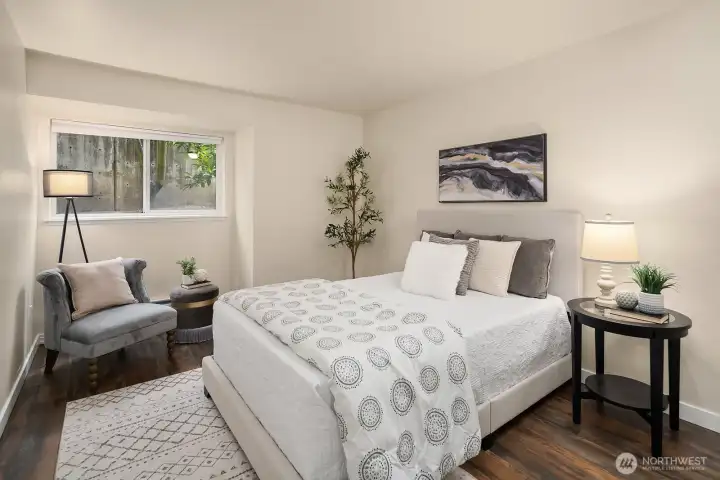Comfortable second bedroom with hardwood floors, ample natural light, and a versatile layout suitable as a guest room, home office, or personal retreat. Comfortable second bedroom with hardwood floors, ample natural light, and a versatile layout suitable as a guest room, home office, or personal retreat.