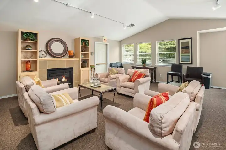 Spacious clubhouse living area featuring a cozy fireplace, comfortable seating, and warm finishes, ideal for resident entertaining and community events. Spacious clubhouse living area featuring a cozy fireplace, comfortable seating, and warm finishes, ideal for resident entertaining and community events.