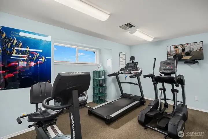 Fully equipped fitness center featuring cardio machines and modern equipment, allowing residents to maintain an active lifestyle without leaving home. Fully equipped fitness center featuring cardio machines and modern equipment, allowing residents to maintain an active lifestyle without leaving home.