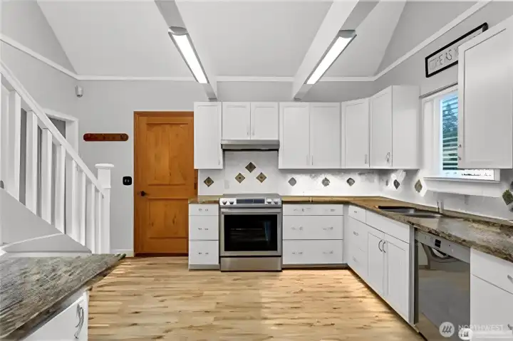 The kitchen features granite counters, tile backsplash, white cabinets and skylights and more! The kitchen features granite counters, tile backsplash, white cabinets and skylights and more!