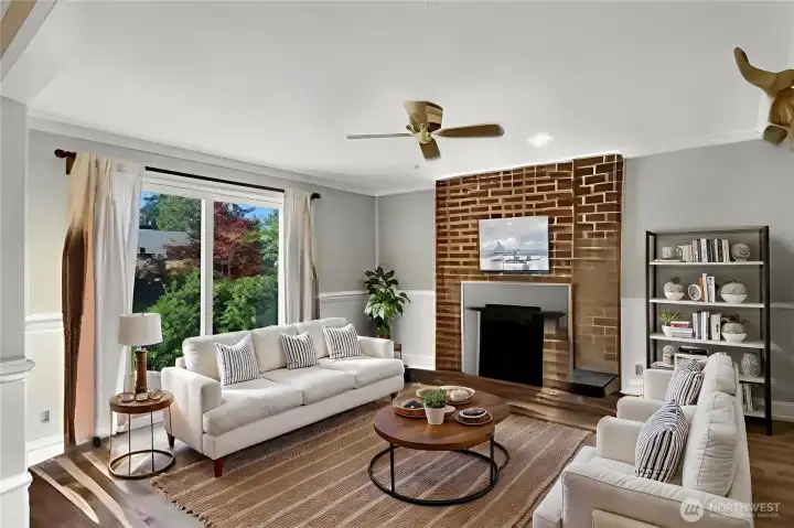 The family room features a fireplace, ceiling fan and access to a large deck. The family room features a fireplace, ceiling fan and access to a large deck.