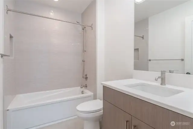 Main floor bathroom with tub and heated floors